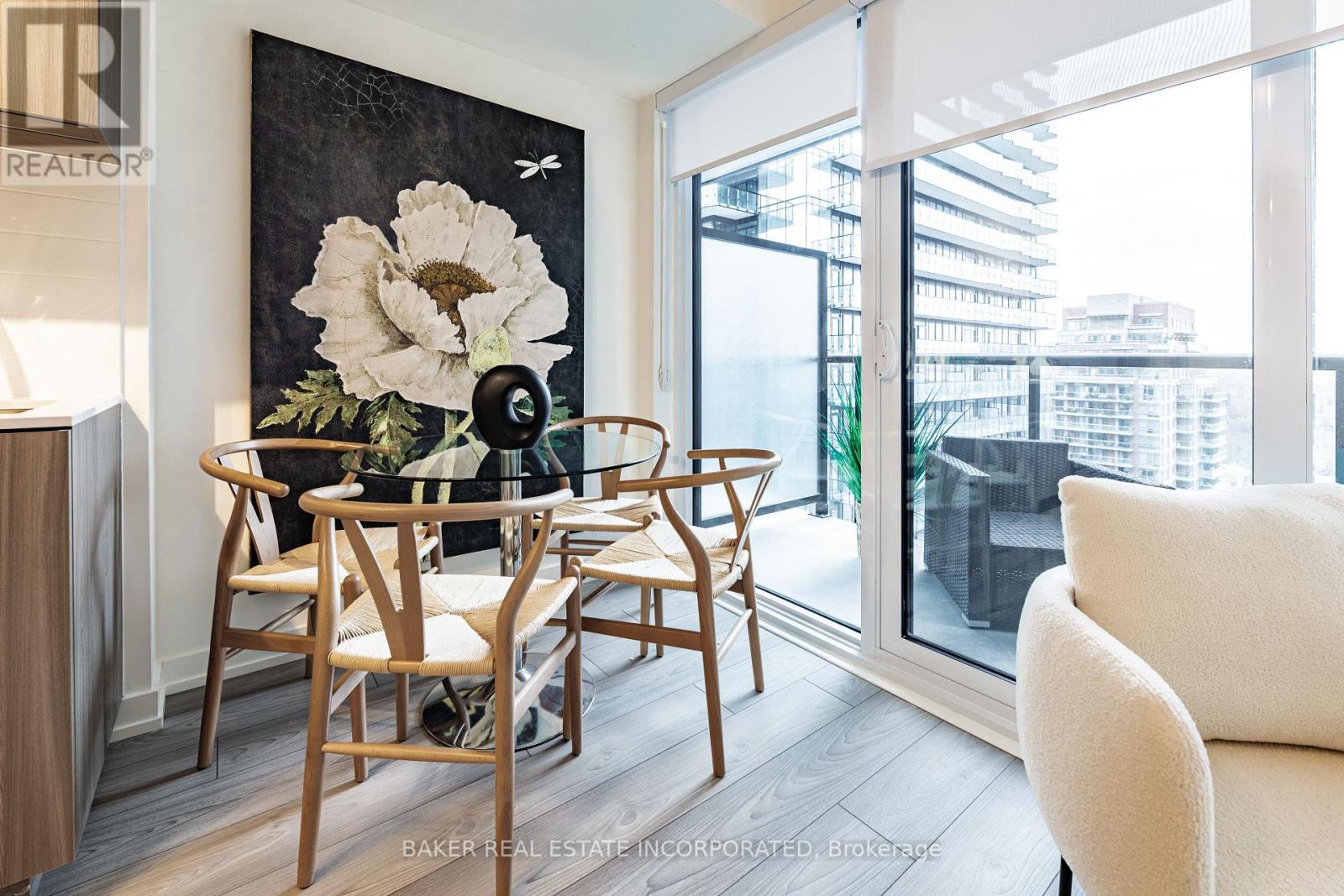 A dining room with a wooden table and chairs.