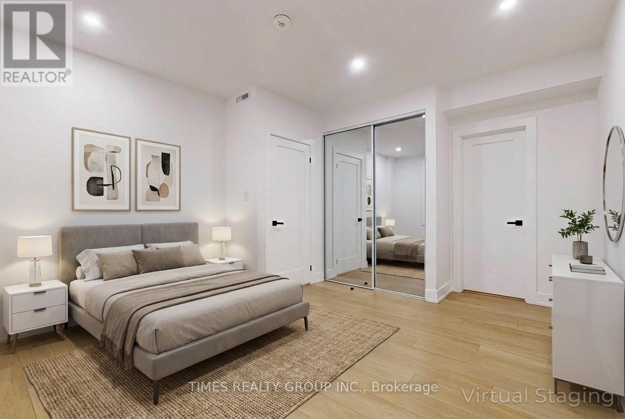 A bedroom with a large bed, two nightstands, and a mirrored doorway leading to another room.
