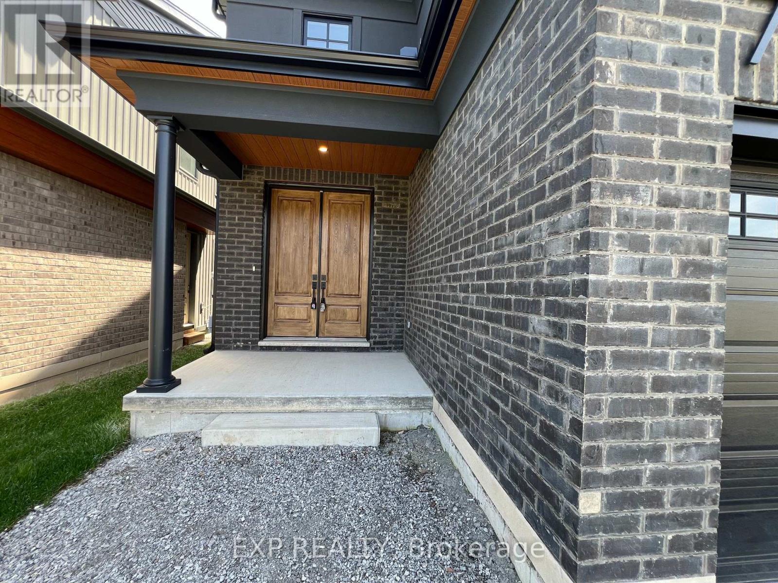 A house with a wooden door and a brick wall.