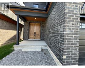 A house with a wooden door and a brick wall.