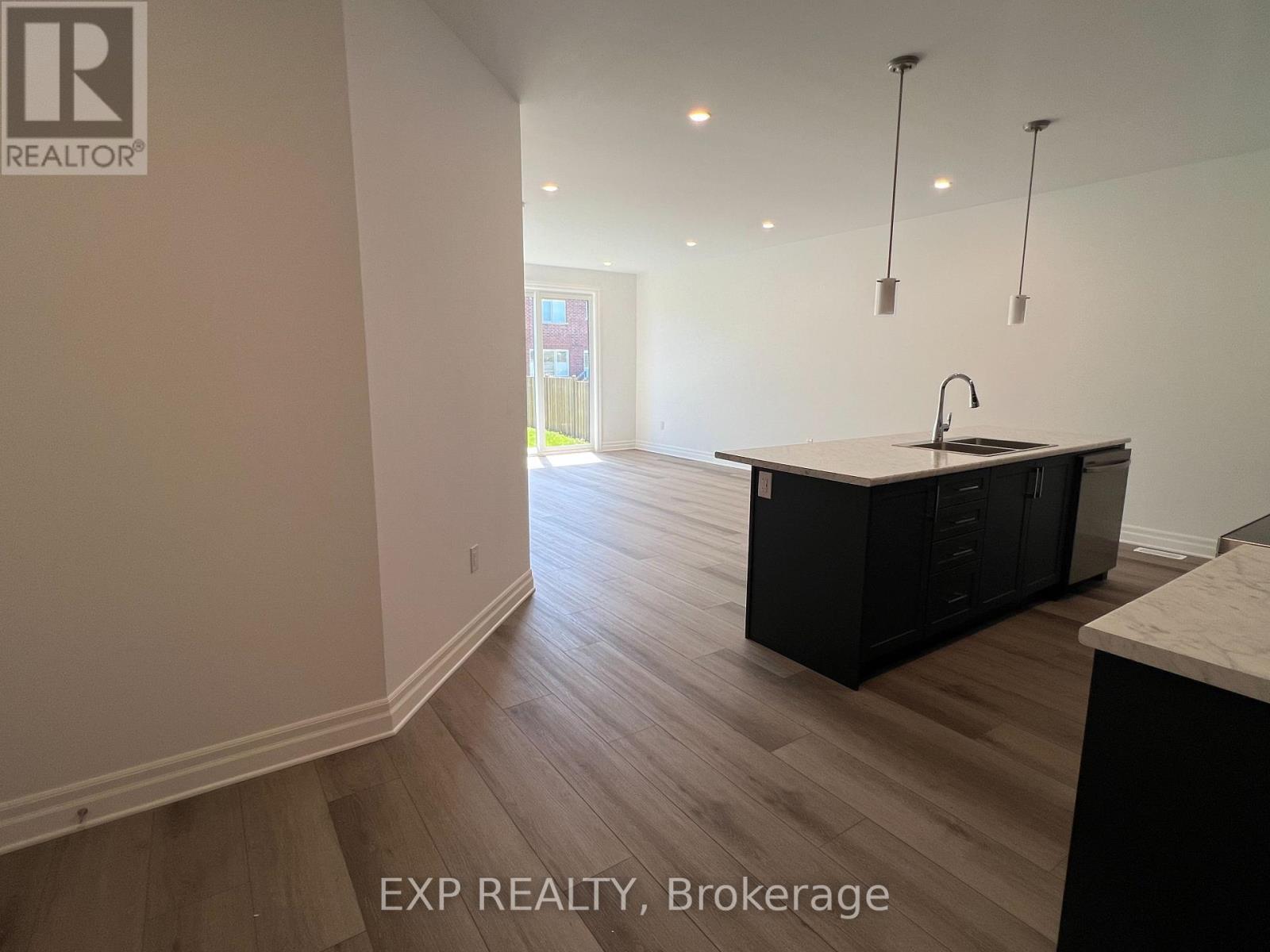 A kitchen with a sink and cabinets is shown in this image.