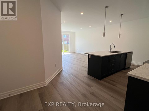 A kitchen with a sink and cabinets is shown in this image.