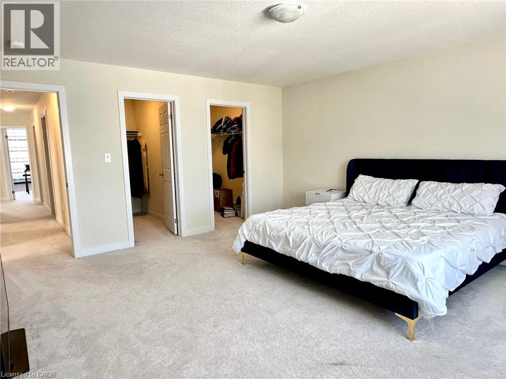 A bedroom with a bed, dresser, and closet.