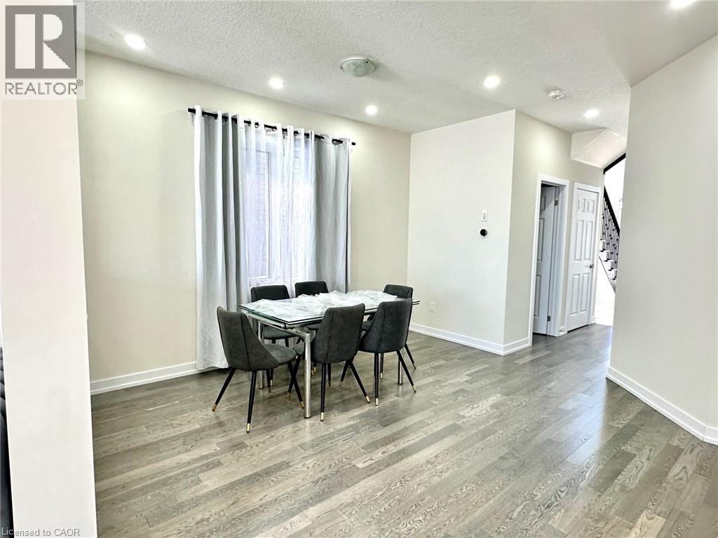 A dining room with a table and chairs.