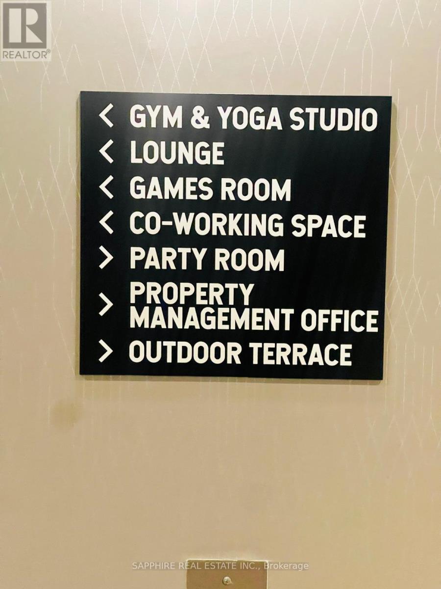 A sign lists amenities such as a gym, lounge, and games room.