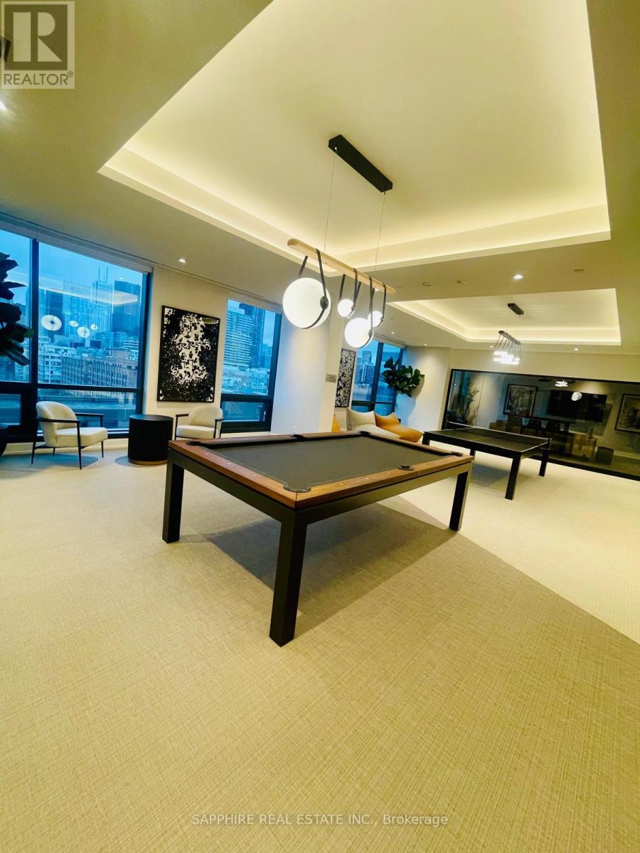 A room with a pool table and a chair.