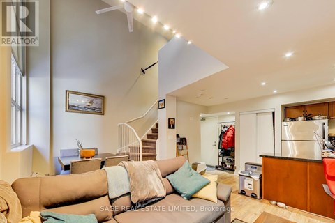 A living room with a couch and a fan.