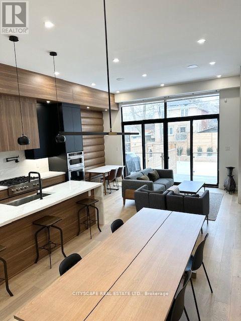 A modern kitchen with a dining table and chairs.