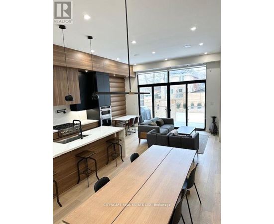 A modern kitchen with a dining table and chairs.