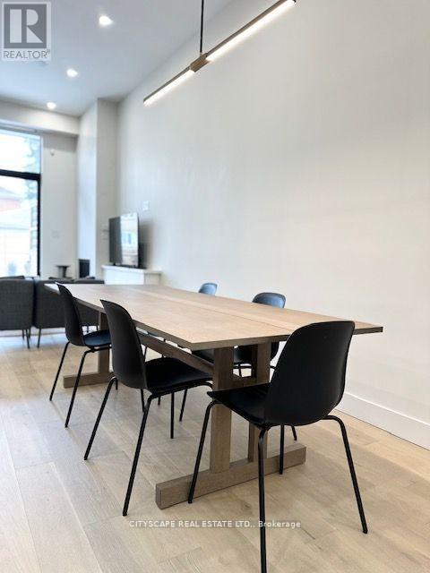 A conference room with a long table and chairs.