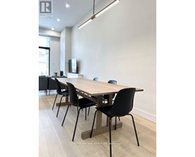 A conference room with a long table and chairs.