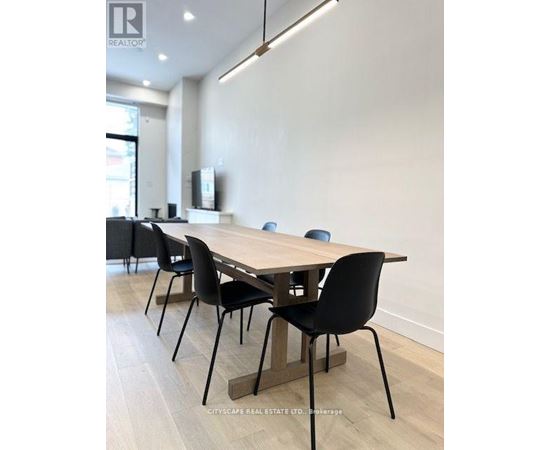 A conference room with a long table and chairs.