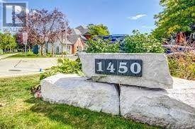 A stone sign with the number 1450 on it is mounted on a rock.