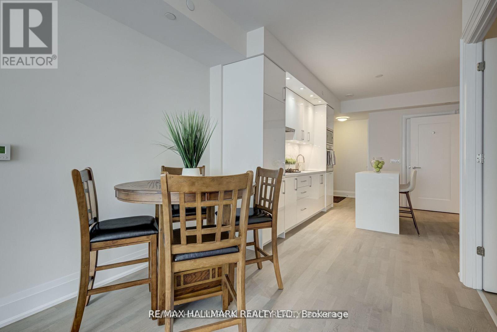 A dining room with a table and chairs.