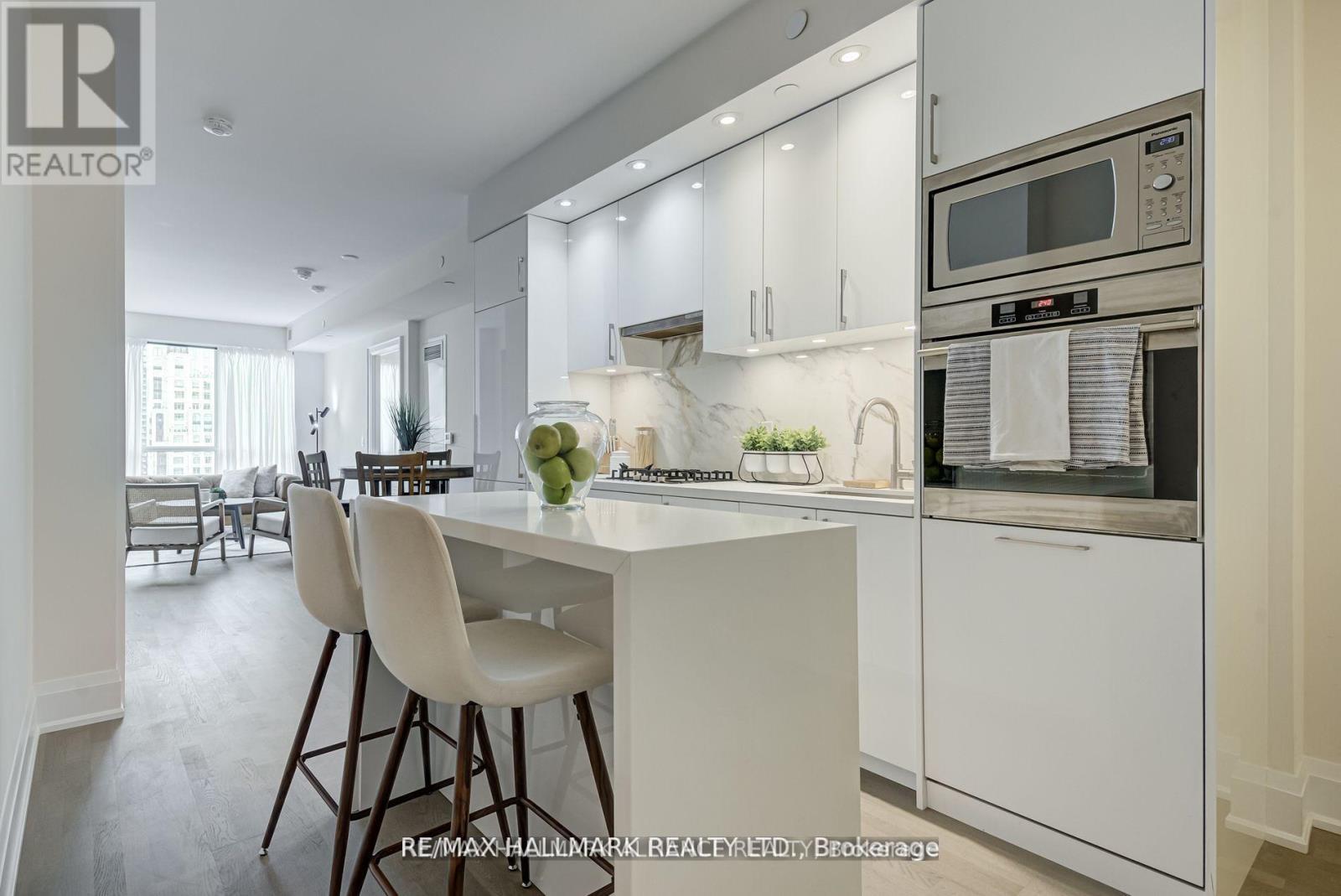A modern kitchen with white cabinets and a breakfast bar.