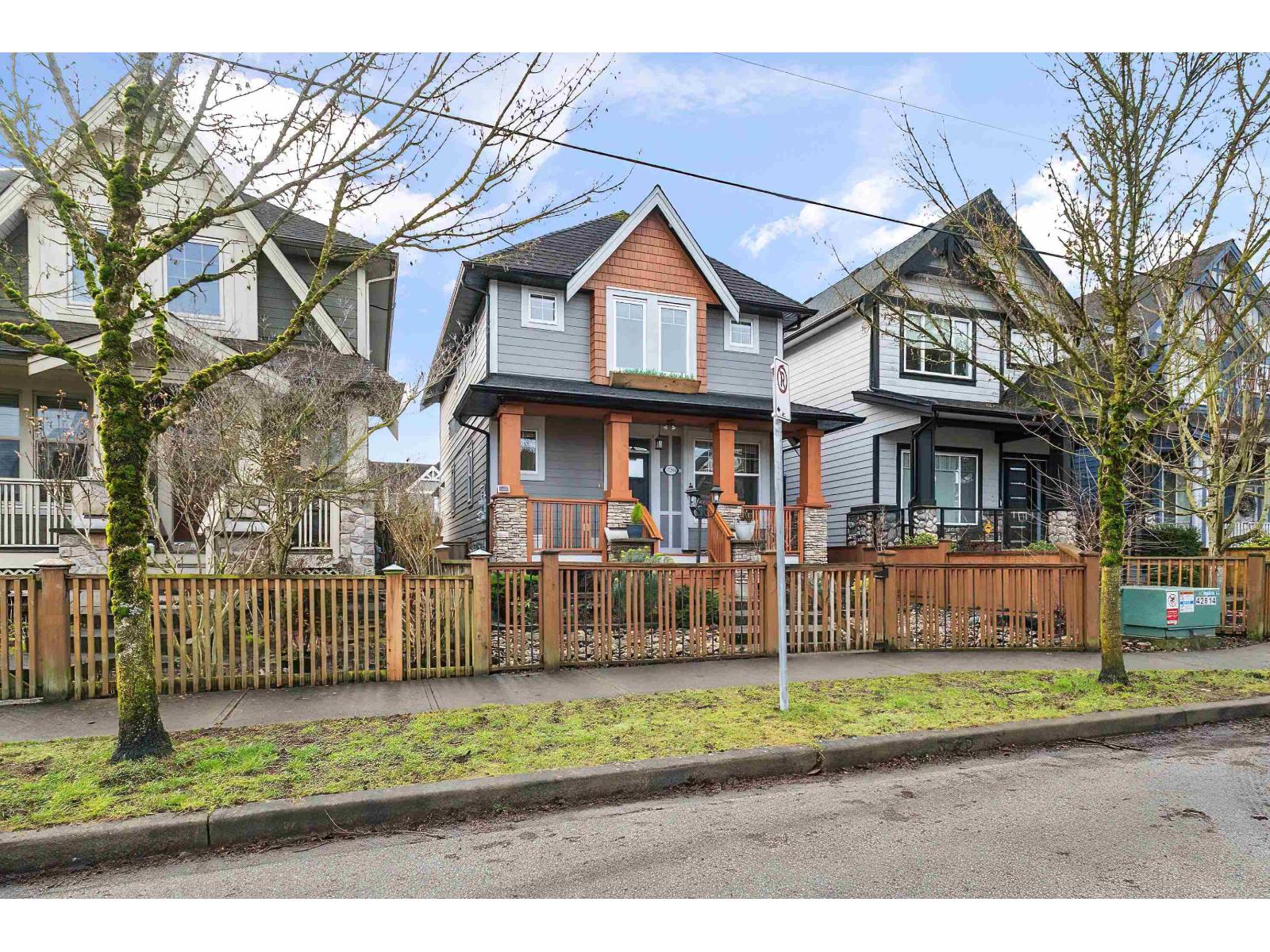 A row of houses with a fence in front.