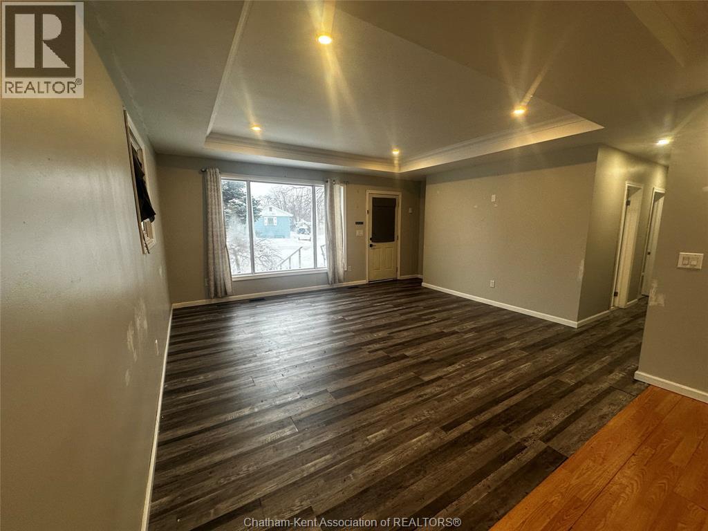 A room with wood flooring and a slanted ceiling.