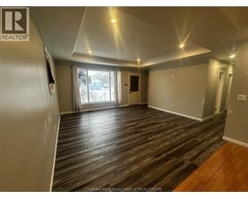 A room with wood flooring and a slanted ceiling.