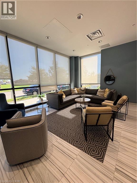 A modern living room with a large window and a variety of seating options.