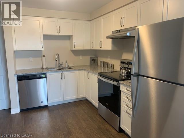 A kitchen with white cabinets and stainless steel appliances.