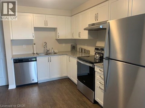 A kitchen with white cabinets and stainless steel appliances.
