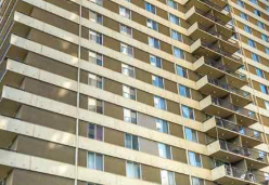 A tall building with many windows and balconies.