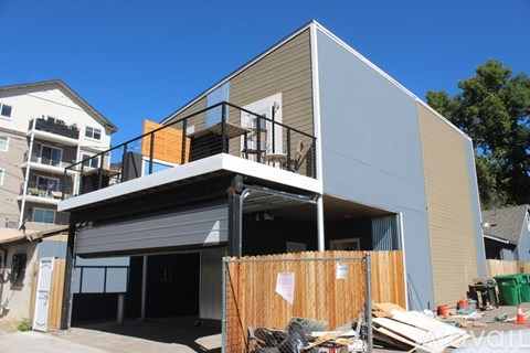 A house under construction with a grey roof and a balcony.