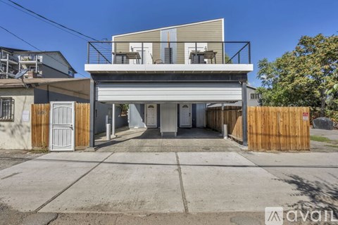 A garage door is open to a small, dark room.