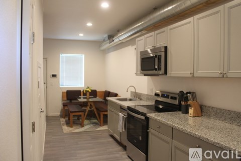 A kitchen with a microwave above the stove.
