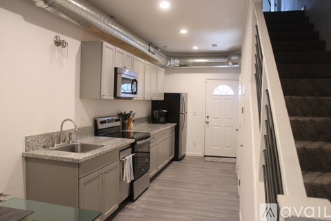 A kitchen with a stove top oven and a microwave above the stove.