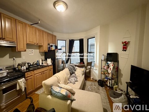 A kitchen with wooden cabinets and a stove top oven.