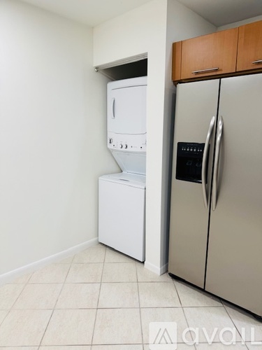 A kitchen with a white dishwasher and a silver refrigerator.