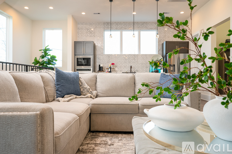 A living room with a beige sofa and a coffee table.