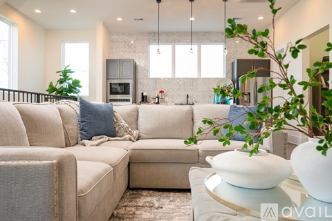 A living room with a beige sofa and a coffee table.