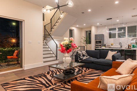 A living room with a zebra print rug and a black and white striped couch.