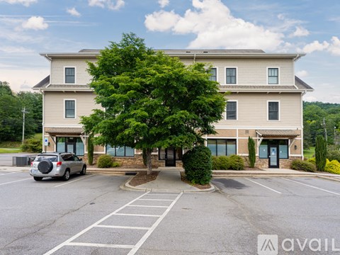 A large building with a parking lot in front of it.