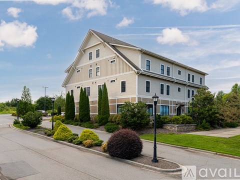 A large house with a lawn in front of it.