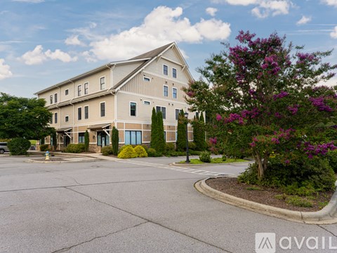 A large building with a parking lot in front of it.