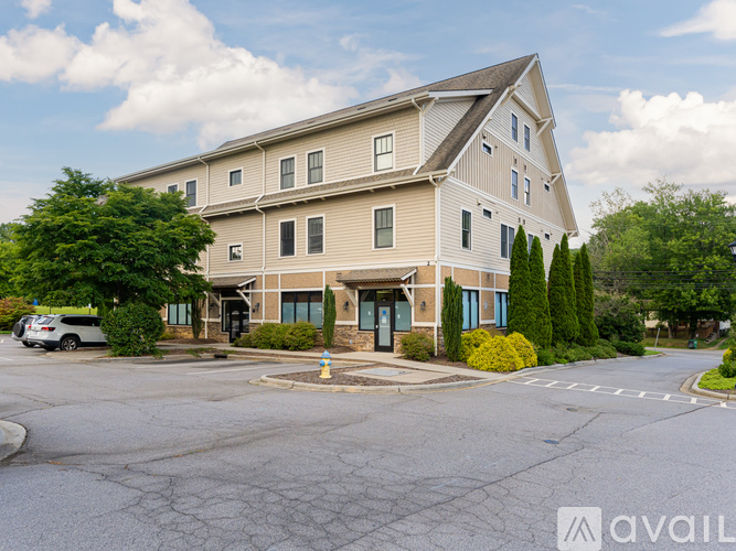 A large two-story building with a parking lot in front.