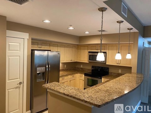 A kitchen with granite countertops and stainless steel appliances.