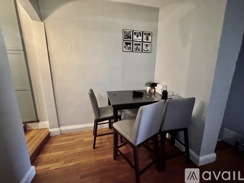 A dining room with a table and chairs.