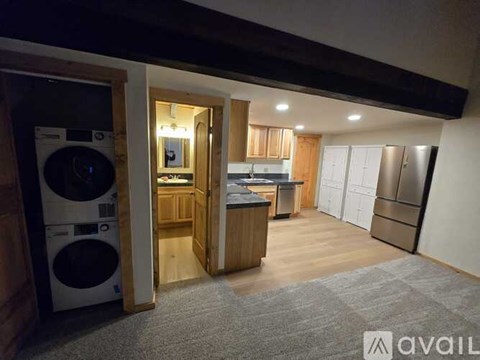 A laundry room with a washer and dryer stacked on top of each other.