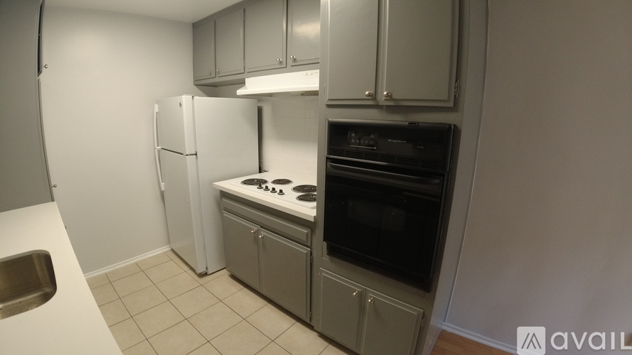 A kitchen with a white refrigerator, a stove, and a dishwasher.