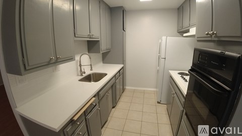 A kitchen with white cabinets and appliances.