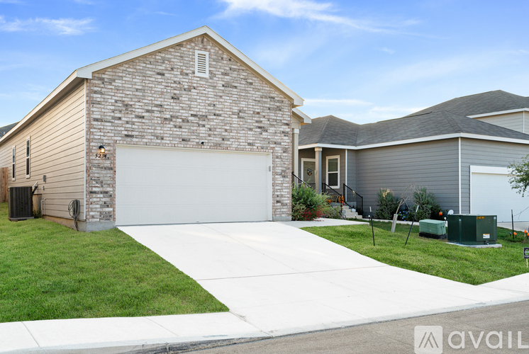 A house with a garage and driveway in front.