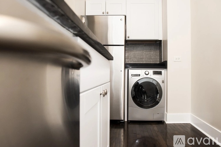 A modern kitchen with a dishwasher and a washing machine.