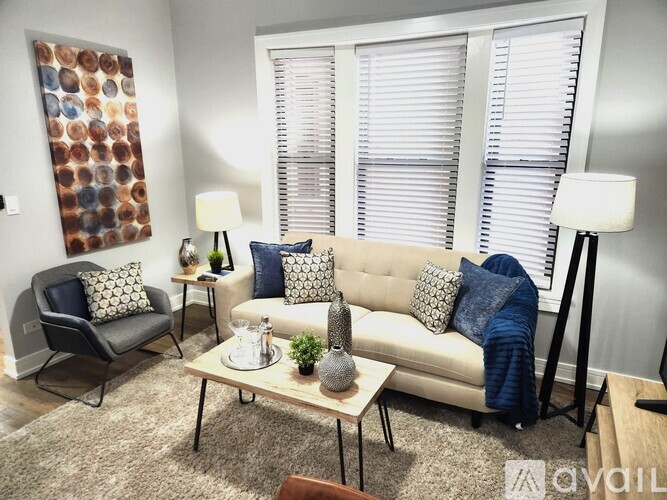 A living room with a sofa, armchair, and coffee table.