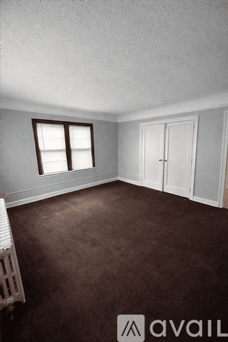 A room with brown carpet and a white door.