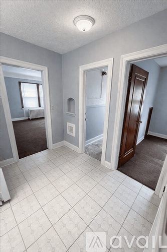 A room with a white tile floor and a window.