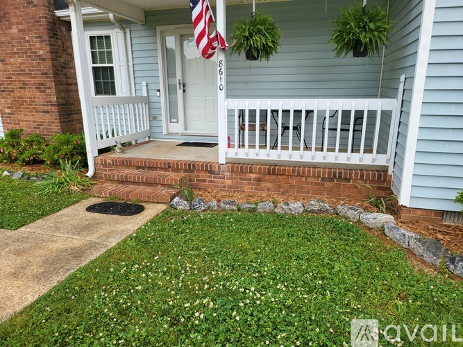 A house with a blue siding and a white door with a flag on it.